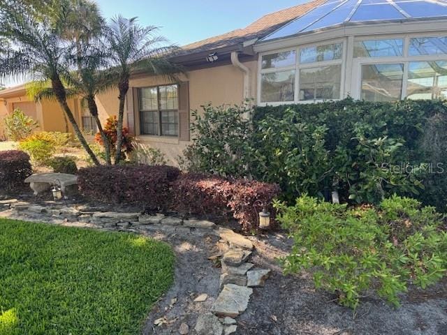 view of side of property featuring a sunroom