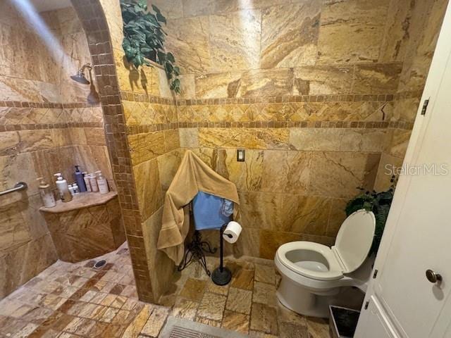 bathroom with a shower and toilet