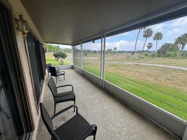 sunroom featuring a rural view