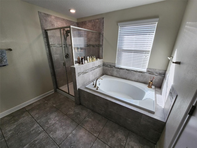 bathroom featuring tile patterned floors, a textured ceiling, and shower with separate bathtub