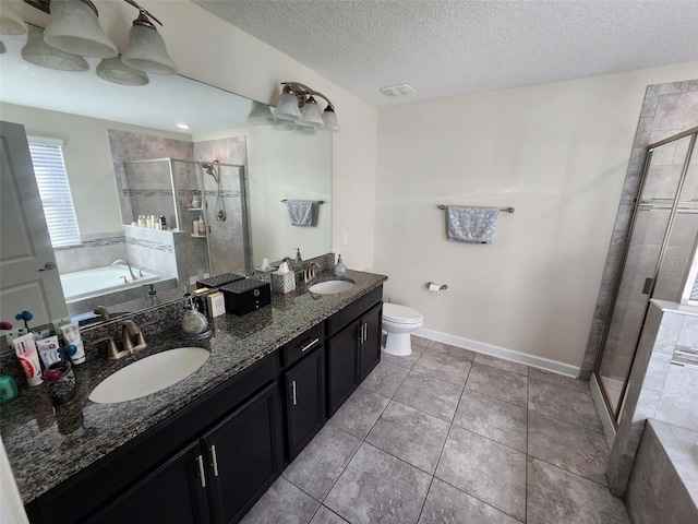 full bathroom with tile patterned floors, a textured ceiling, toilet, vanity, and independent shower and bath