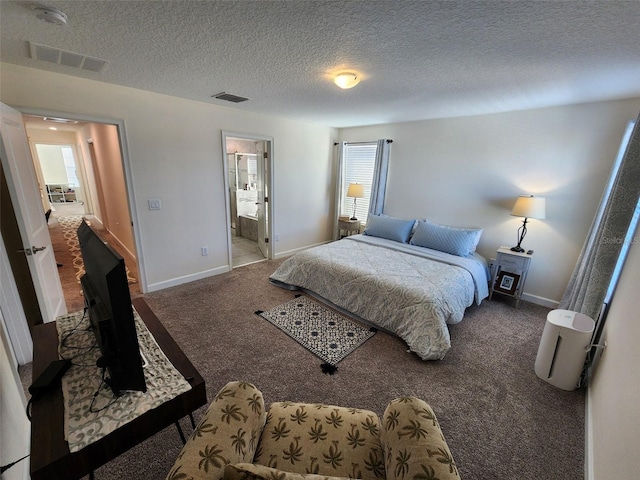 bedroom featuring a textured ceiling, carpet floors, and ensuite bathroom