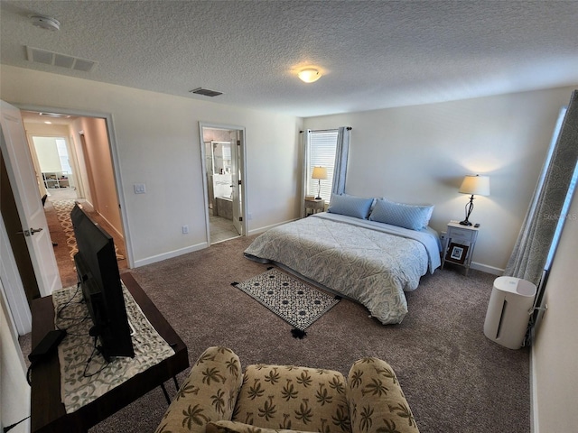 carpeted bedroom featuring a textured ceiling and ensuite bathroom