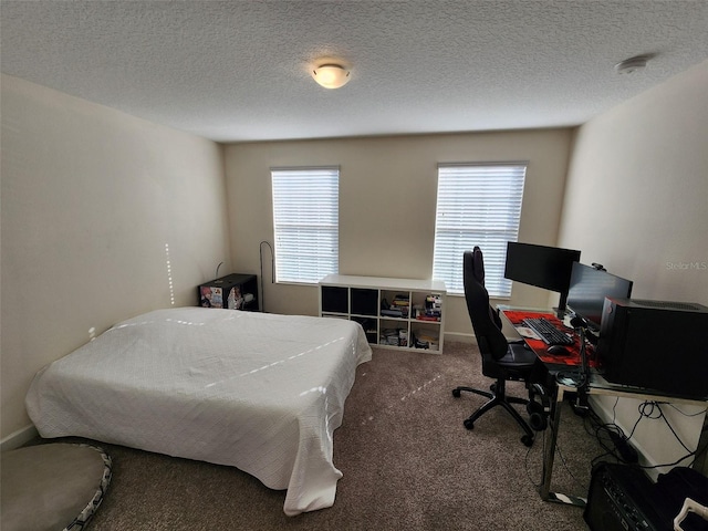 carpeted bedroom featuring multiple windows and a textured ceiling