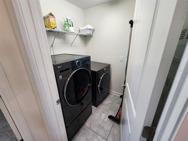 laundry room with light tile patterned flooring and separate washer and dryer