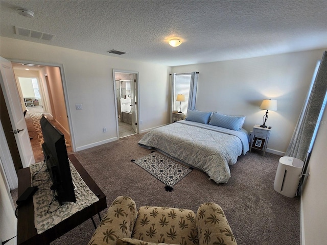 bedroom featuring ensuite bathroom, carpet floors, and a textured ceiling