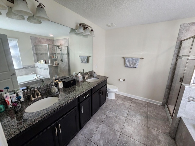 full bathroom featuring separate shower and tub, tile patterned floors, a textured ceiling, toilet, and vanity