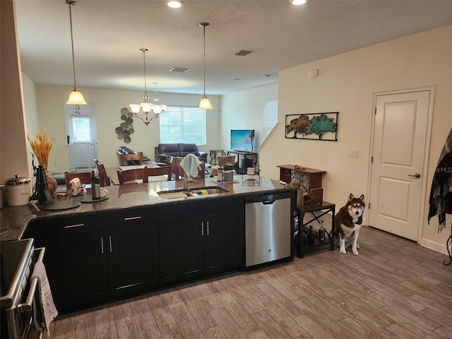 kitchen featuring stainless steel dishwasher, light hardwood / wood-style floors, range, and hanging light fixtures