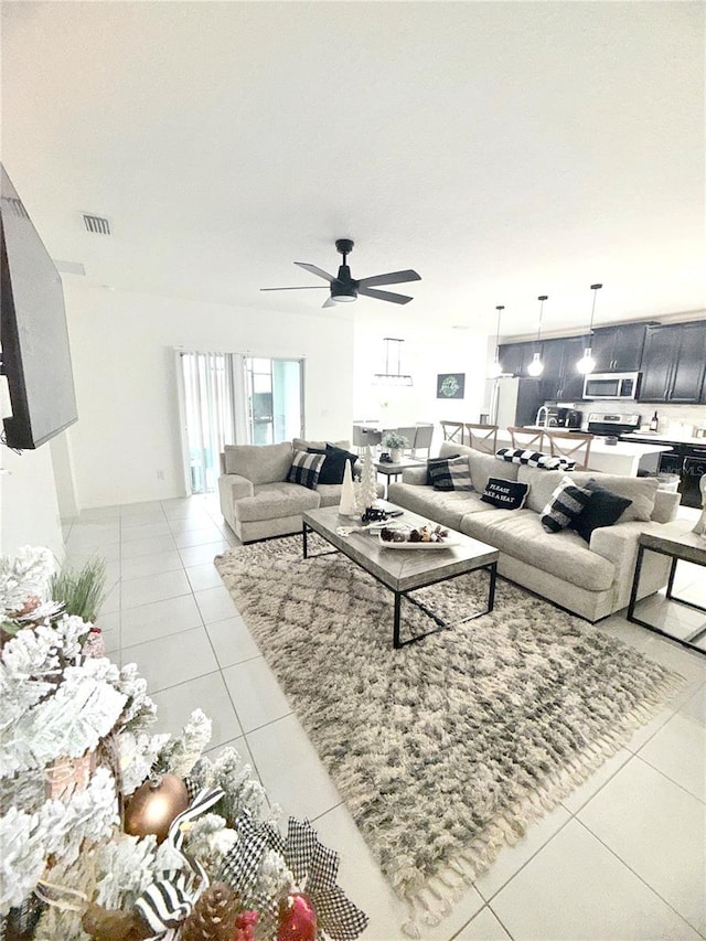 tiled living room with ceiling fan