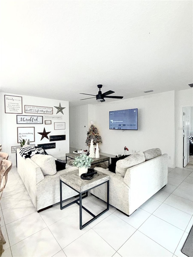 living room featuring light tile patterned floors and ceiling fan