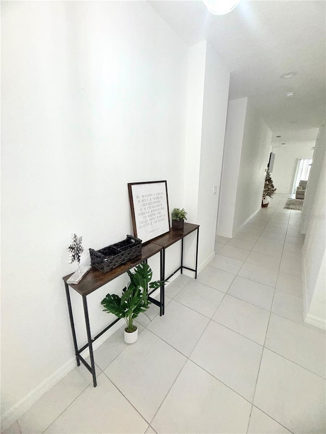 hall with light tile patterned floors