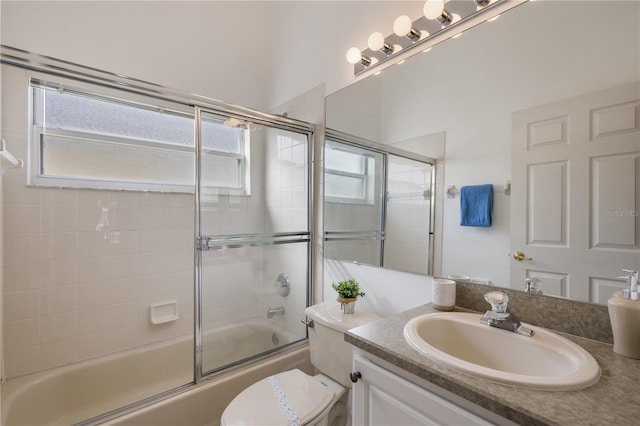 full bathroom featuring vanity, toilet, and enclosed tub / shower combo