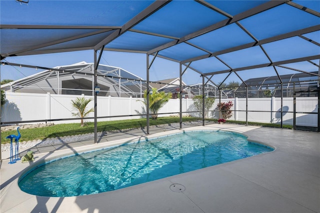 view of pool with glass enclosure and a patio area