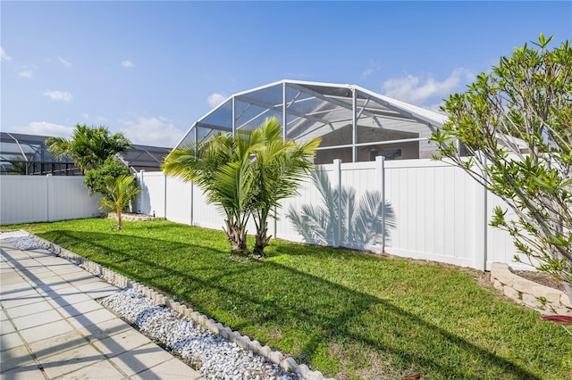 view of yard with glass enclosure