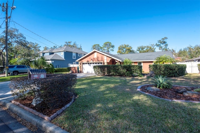 view of front of house featuring a garage and a front lawn