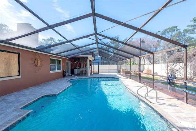 view of pool with a patio area and a lanai