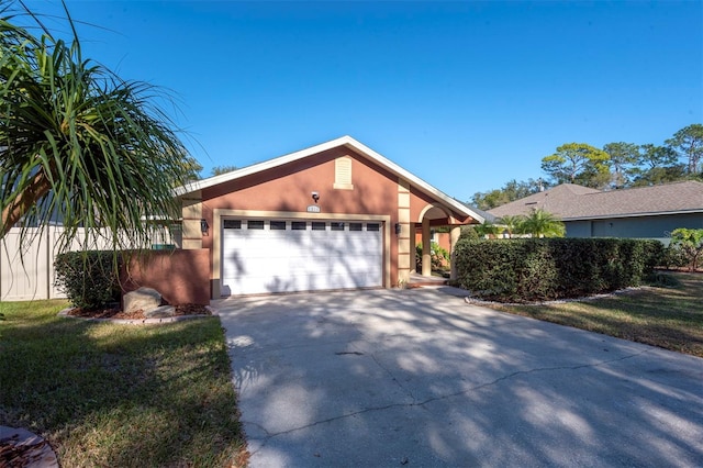 view of front of home with a garage and a front lawn