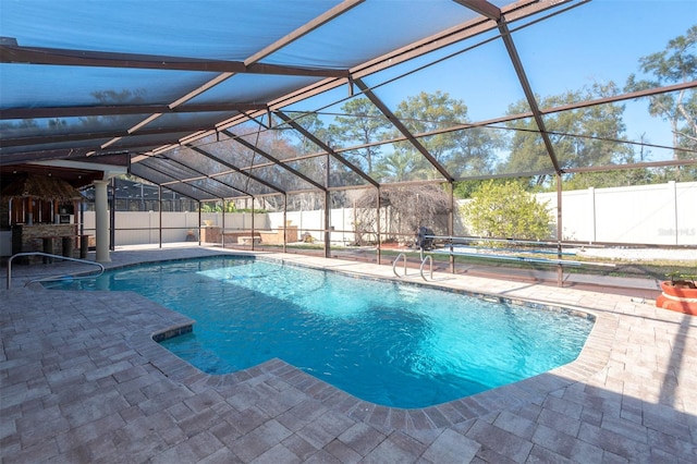 view of pool with a lanai, a patio area, and exterior bar