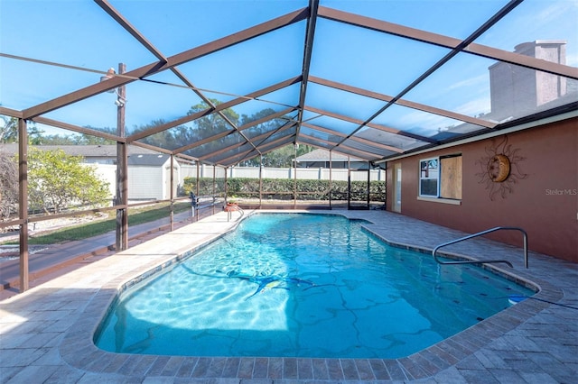 view of swimming pool featuring a lanai and a patio area