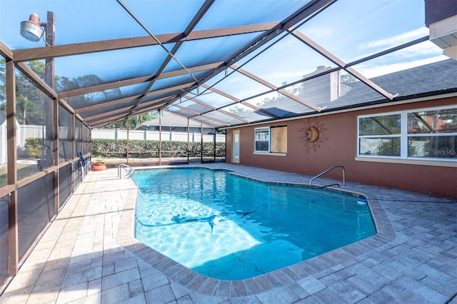 view of pool featuring glass enclosure and a patio area