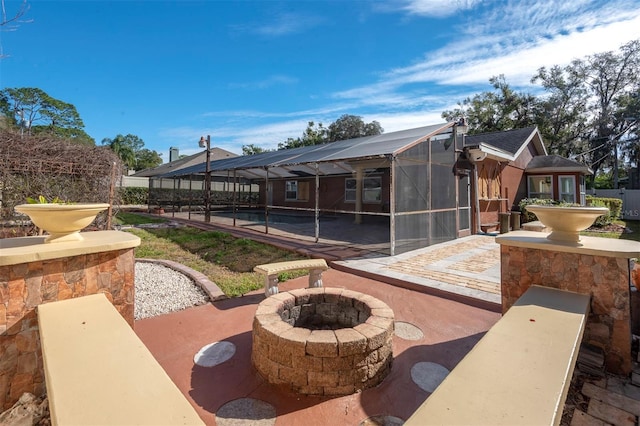 view of patio with a pool, a lanai, and a fire pit