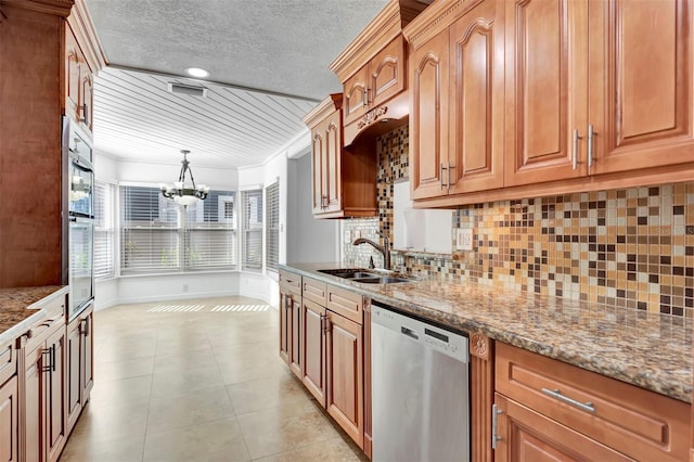 kitchen featuring sink, hanging light fixtures, stainless steel dishwasher, light stone countertops, and a notable chandelier