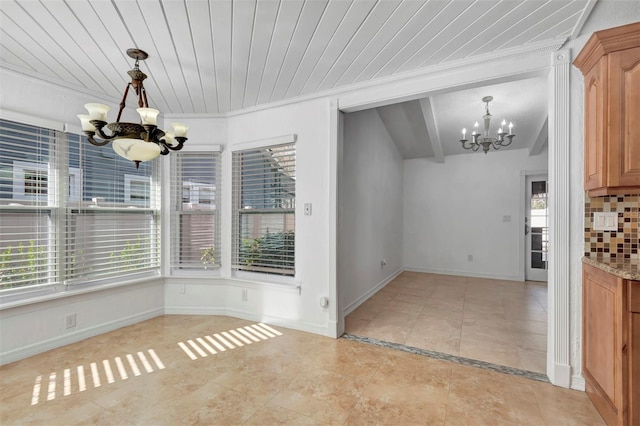 unfurnished dining area featuring a notable chandelier, light tile patterned floors, and crown molding