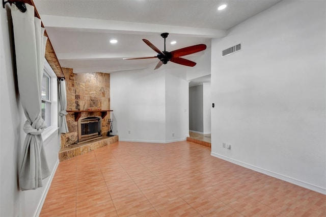 living room with lofted ceiling with beams, a stone fireplace, and ceiling fan