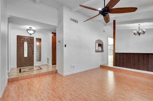 entryway with a wealth of natural light, vaulted ceiling with beams, a textured ceiling, light tile patterned floors, and ceiling fan with notable chandelier