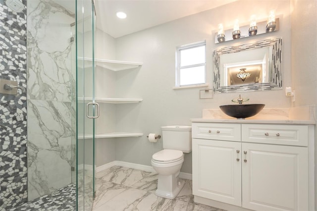 bathroom with vanity, toilet, and a shower with shower door