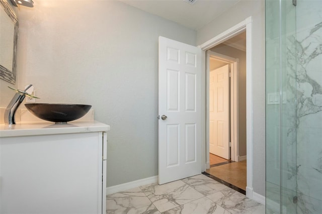 bathroom with a shower with door and vanity