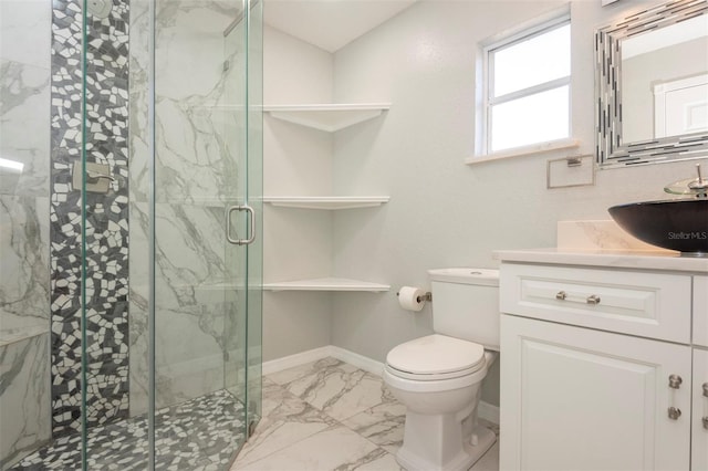 bathroom featuring vanity, toilet, and an enclosed shower