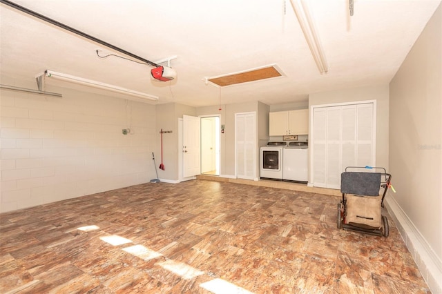 garage with washer and dryer and a garage door opener