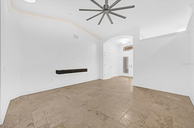 unfurnished living room with ceiling fan and vaulted ceiling