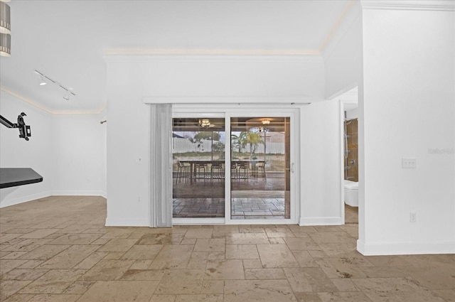 spare room featuring rail lighting and ornamental molding