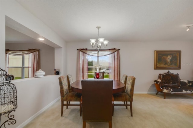 carpeted dining area featuring a textured ceiling and a notable chandelier