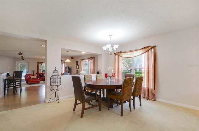 carpeted dining room with a healthy amount of sunlight and a chandelier