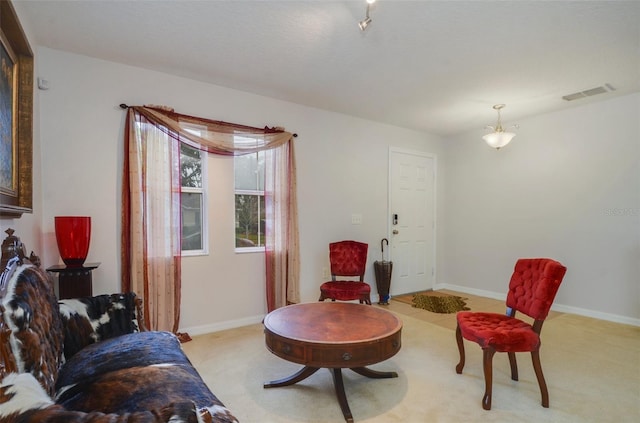 sitting room featuring light colored carpet