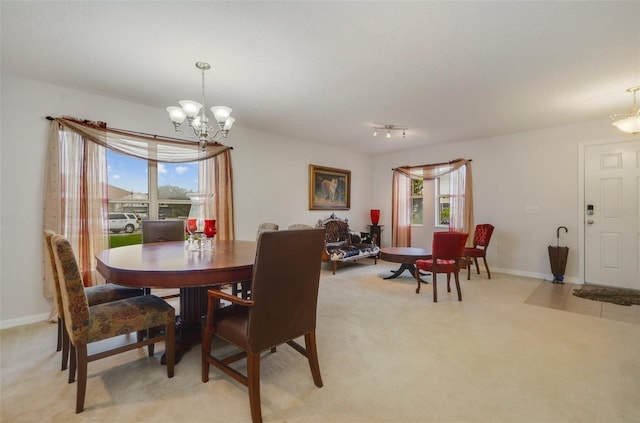 carpeted dining space featuring a notable chandelier