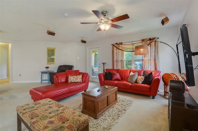 carpeted living room with ceiling fan