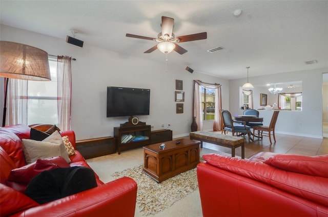 living room with ceiling fan and a textured ceiling