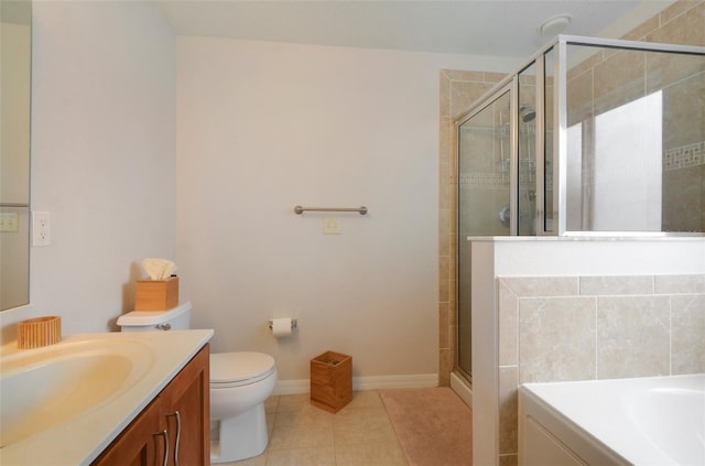 bathroom with tile patterned floors, vanity, toilet, and walk in shower