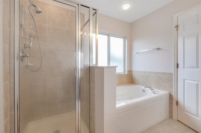 bathroom with tile patterned floors and independent shower and bath