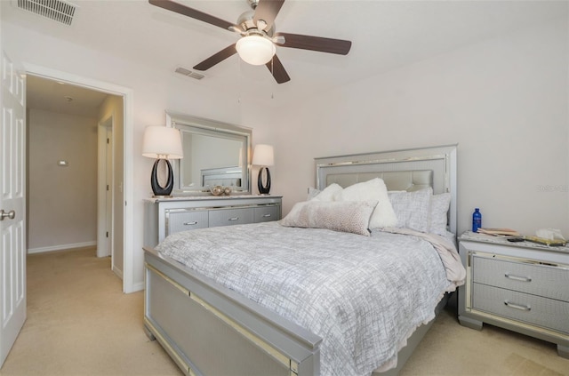 bedroom with ceiling fan and light carpet