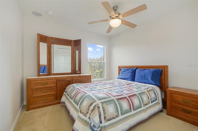 bedroom featuring ceiling fan and light colored carpet