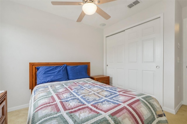 carpeted bedroom with a closet and ceiling fan