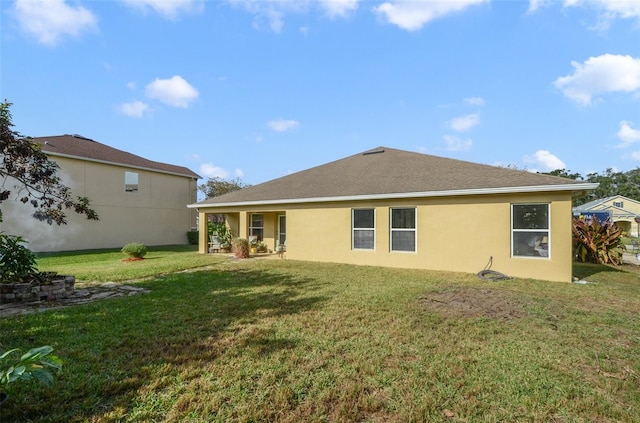 back of house featuring a yard