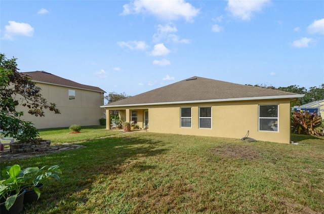 rear view of house featuring a lawn