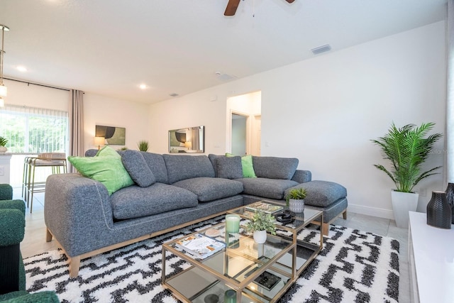 tiled living room with ceiling fan