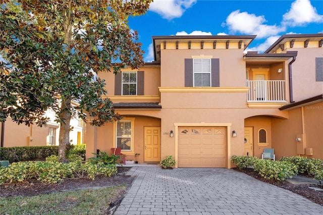 view of front of home featuring a balcony and a garage